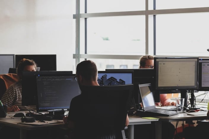 Team of people on computers
